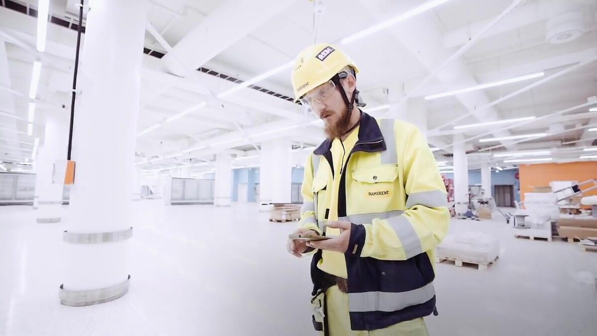 Worker Using Smart Tracker App To Locate Equipment